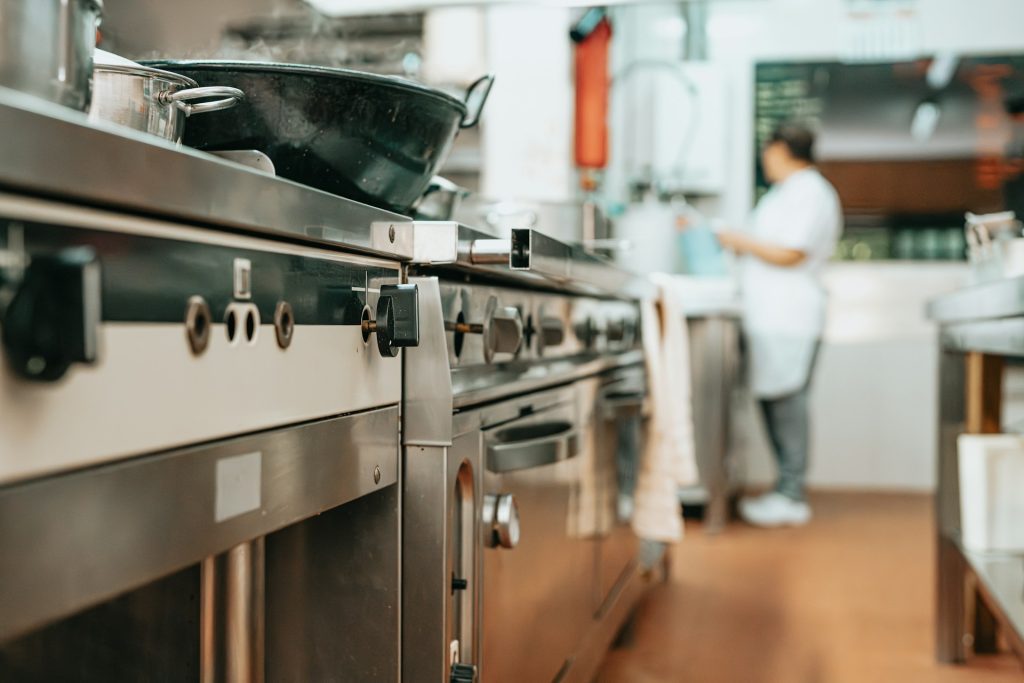 commercial kitchen with commercial range ovens and stovetops